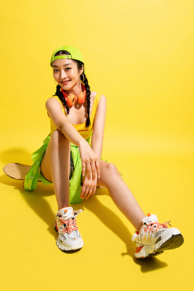 坐在滑板上休息的年轻女孩图片