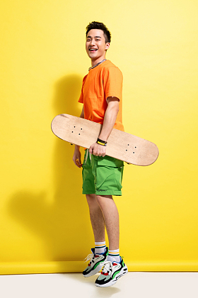 拿着滑板的快乐青年男人照片