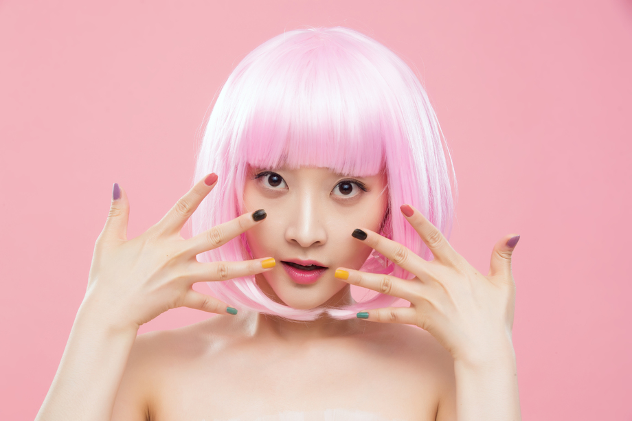 展示彩色指甲油的个性年轻女人