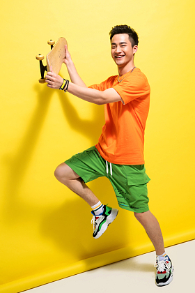 兴奋的青年男人举着滑板图片