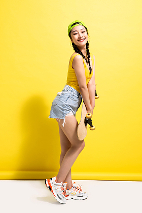 漂亮的青年女人抱着滑板