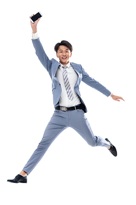 拿着手机奔跑跳跃的商务男士图片