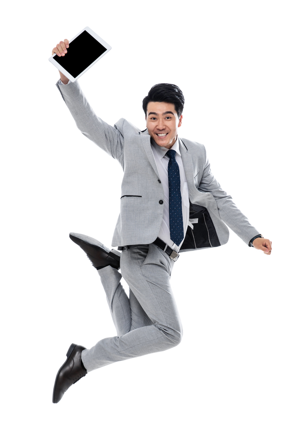 拿着平板电脑跳跃的商务男士照片