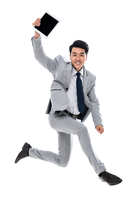拿着平板电脑跳跃的商务男士