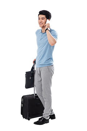 拿行李箱的商务男士打电话照片