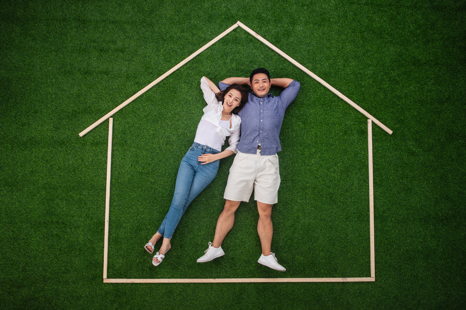 青年伴侣躺在草地上的房子轮廓 青年伴侣躺在草地上的房子轮廓