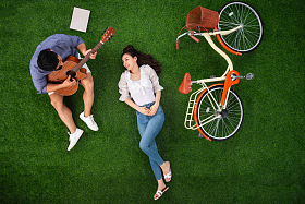 幸福的青年伴侣在草地上享受快乐时光