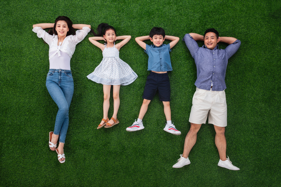 幸福的一家四口躺在草地上图片