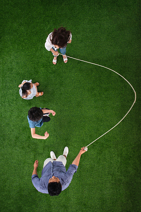 快乐的一家四口在草地上跳绳图片