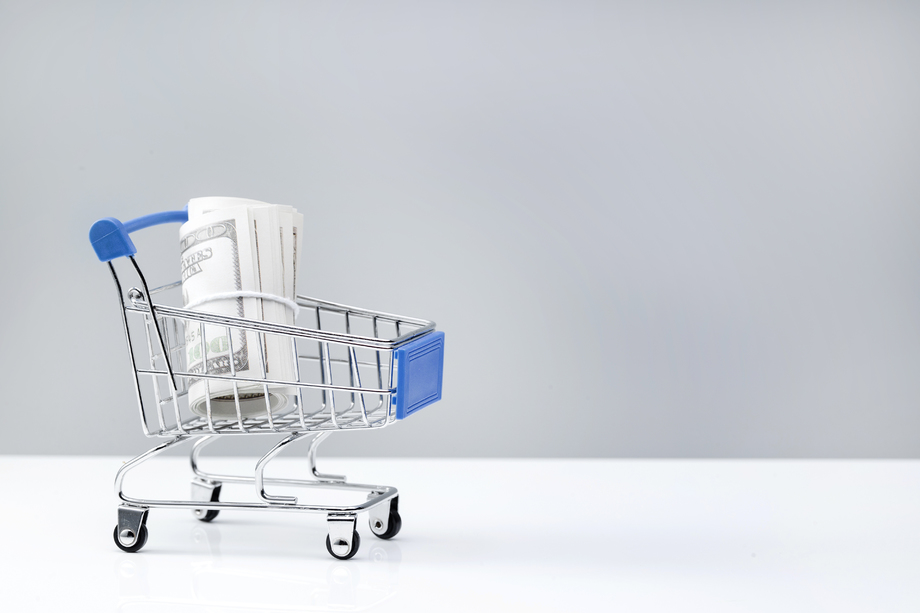 购物车和美国百元钞票卷 购物车和美国百元钞票卷