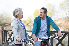 老年夫妇户外骑自行车出游图片