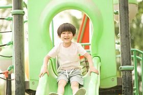 小男孩在户外玩滑梯图片