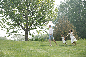 一家三口在草地上放风筝图片