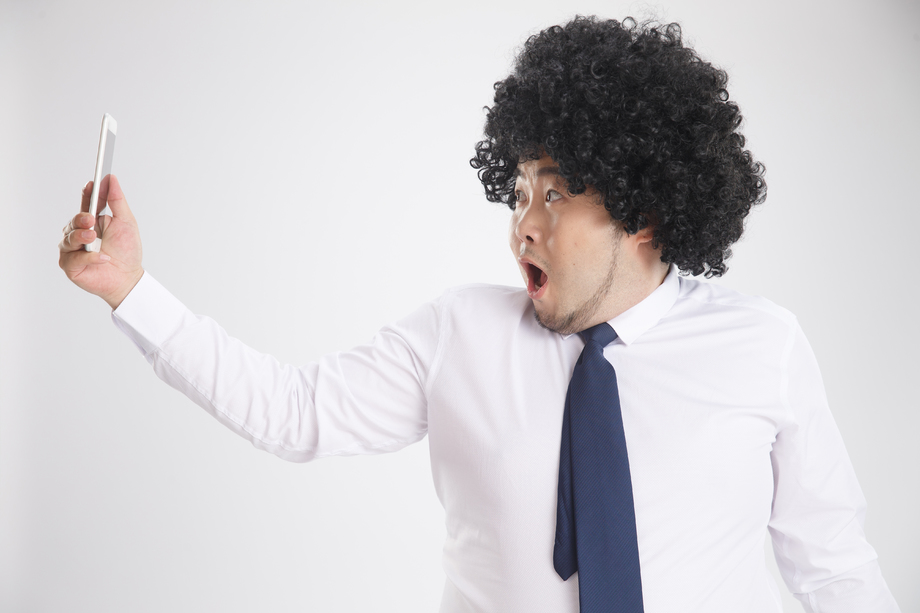 肥胖的商务男人拿着手机照片 肥胖的商务男人拿着手机照片