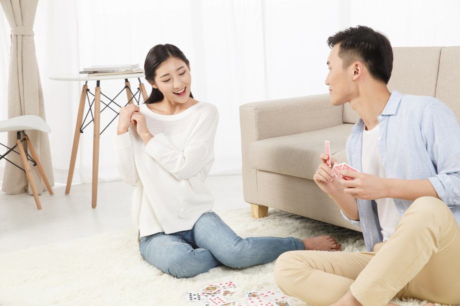 青年情侣玩扑克牌照片