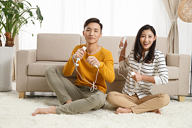 青年情侣坐着沙发上玩游戏图片