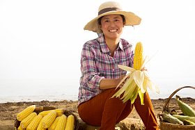 中年女人拿着玉米