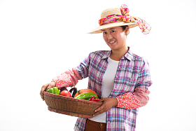 中年女人拿着一筐蔬菜
