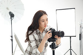 青年女摄影师拿着手机图片