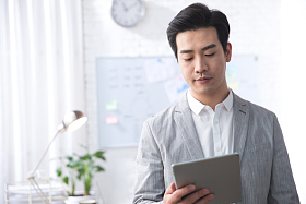 青年商务男人拿着平板电脑办公