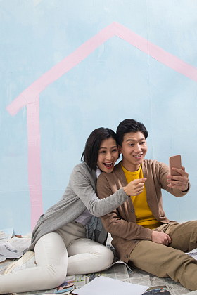 年轻夫妇用手机拍照图片