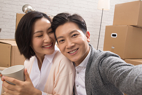 年轻夫妇坐在地板上喝水