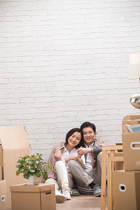 年轻夫妇坐在地板上喝水