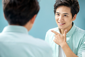 自信的年轻男人对着镜子做手势