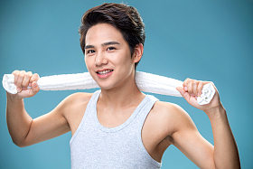 肩膀上搭着毛巾的年轻男人照片