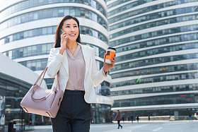 拿着咖啡的商务女性打电话照片