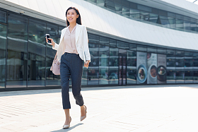 在外面步行的青年商务女人