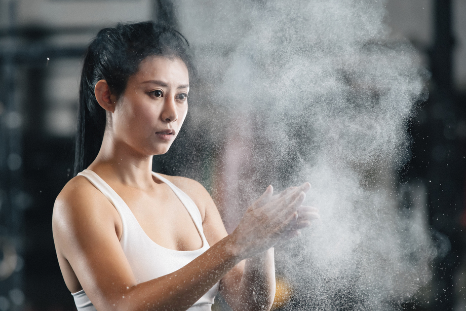 举重运动员往手上涂抹滑石粉 举重运动员往手上涂抹滑石粉