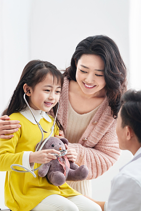 年轻妈妈带着孩子看医生照片
