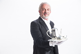 一个男侍者托着银餐具图片