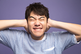 青年男人捂着耳朵