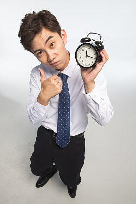 商务青年男人拿着闹钟图片
