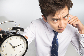 商务青年男人拿着闹钟