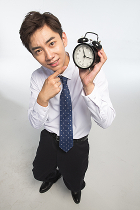 商务青年男人拿着闹钟