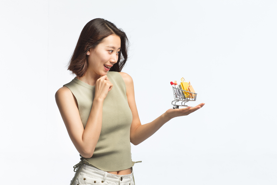 青年女人手托着购物车