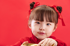 小女孩拿着金元宝过新年照片