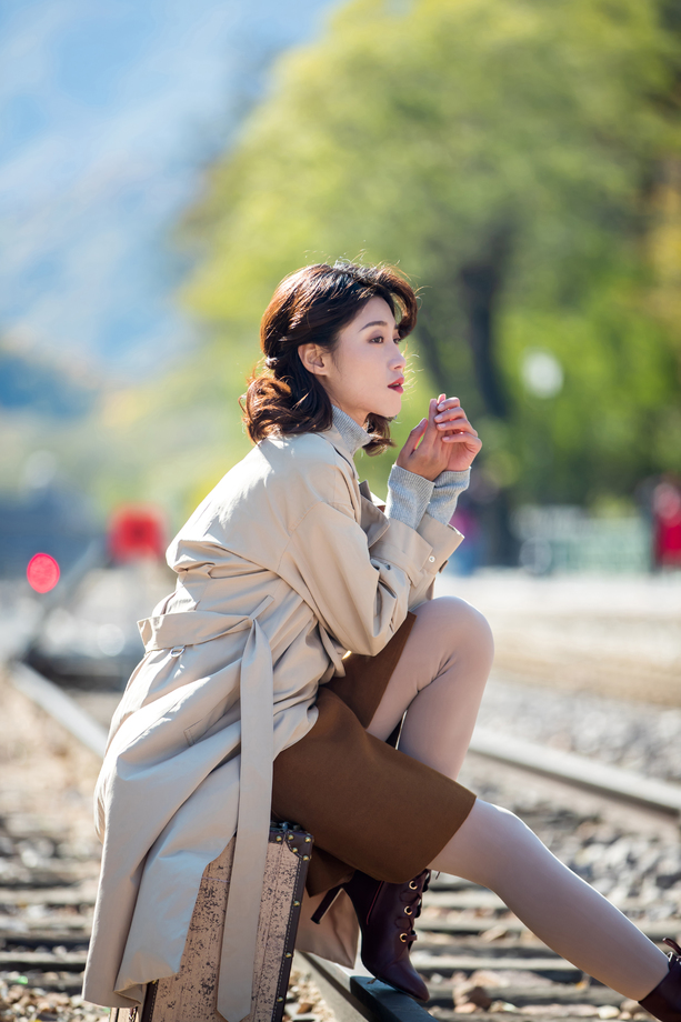青年女人坐在铁轨上