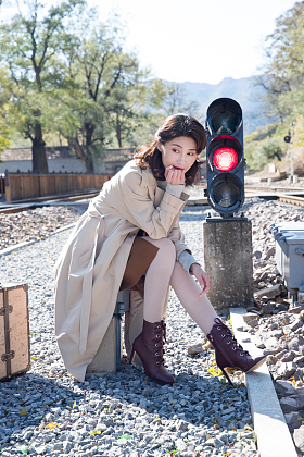 青年女人坐在铁轨旁边